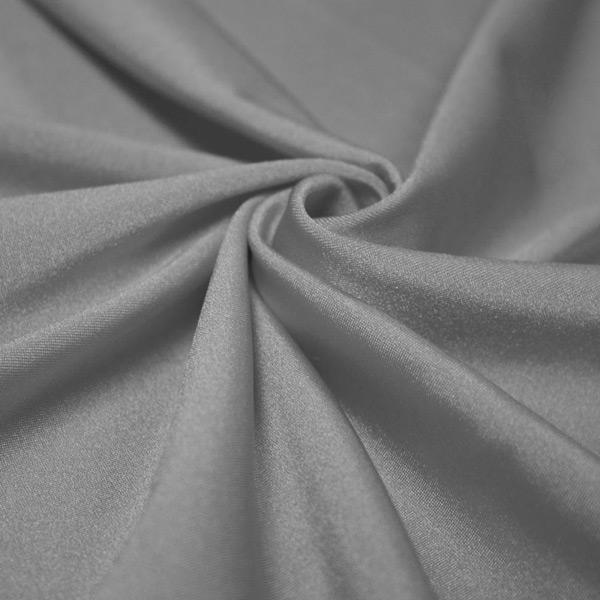 A swirled piece of shiny nylon spandex in the color silver.