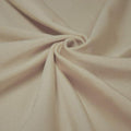 A swirled piece of shiny nylon spandex in the color taupe.