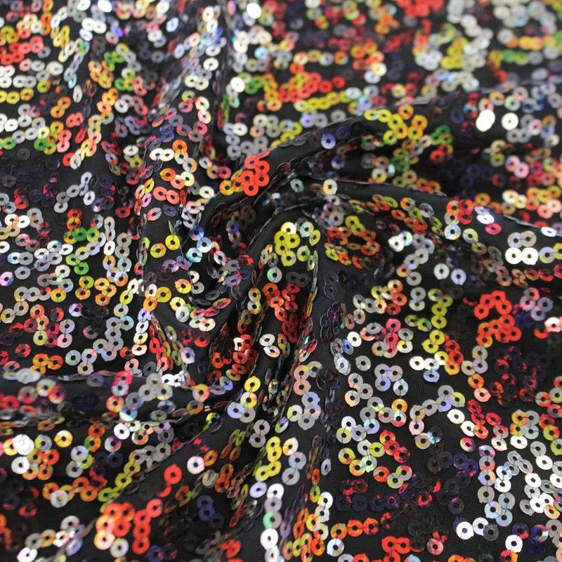 A swirled sample of skittles sequin spandex in the color deep sea black.