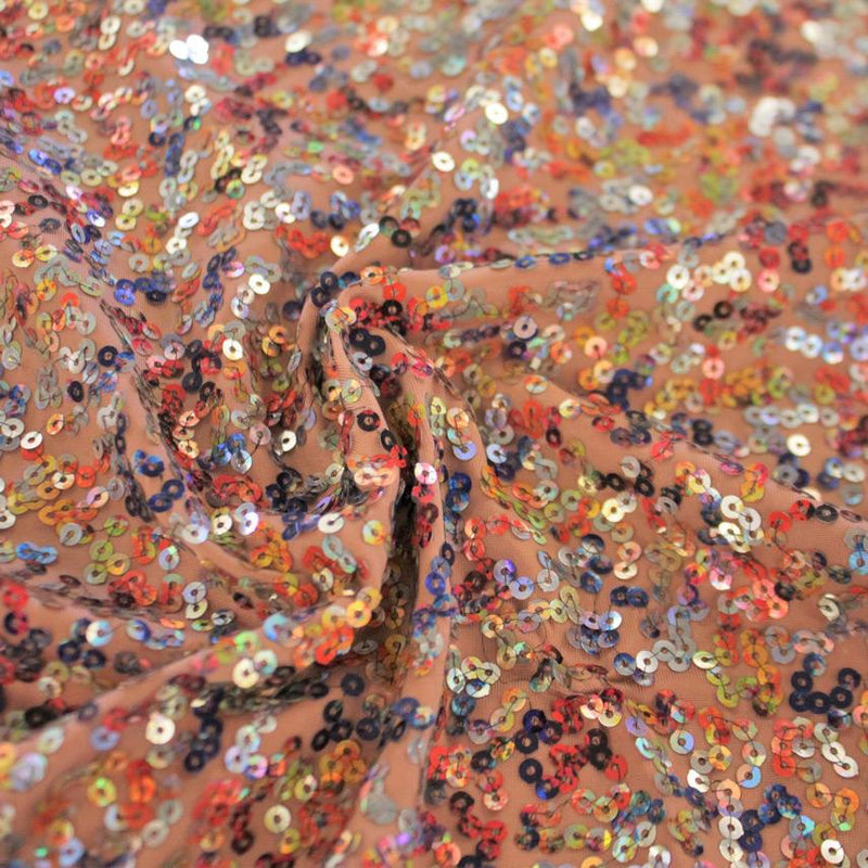 A swirled sample of skittles sequin spandex in the color topaz.