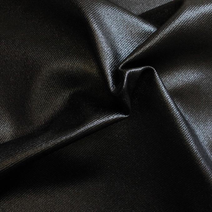 A sample of sleek foiled stretch twill in the color black.