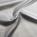 A sample of sleek foiled stretch twill in the color silver.