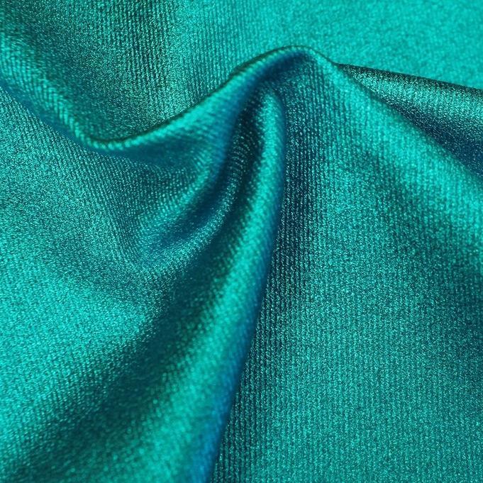 A sample of sleek foiled stretch twill in the color turquoise blue.