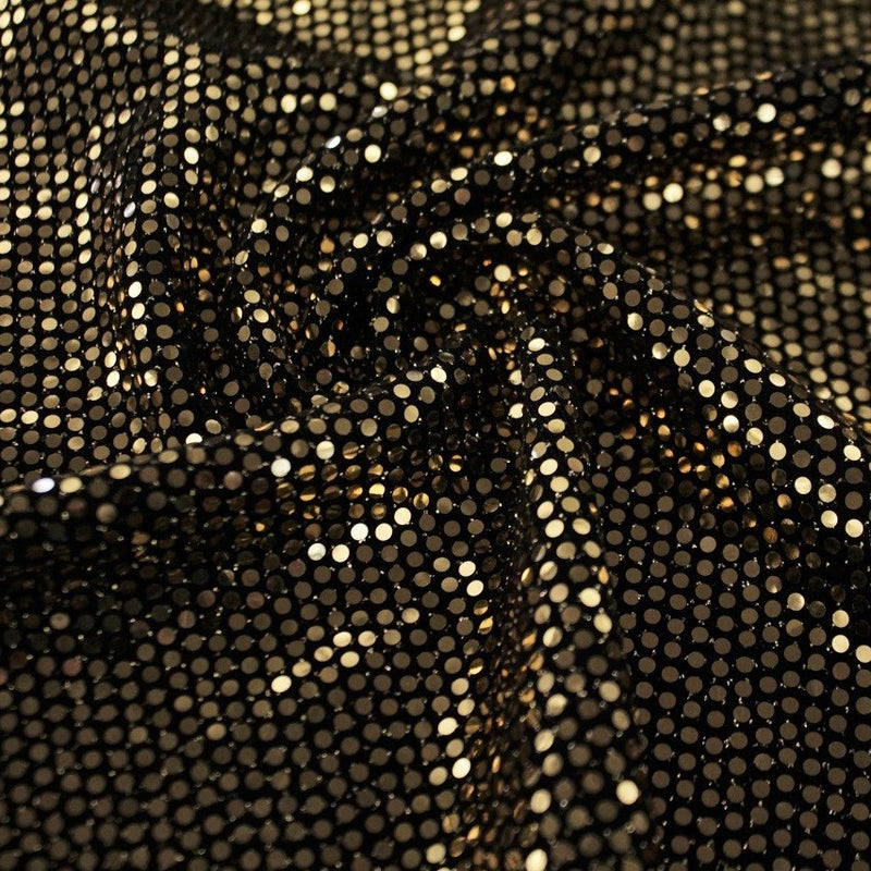 A swirled slink metallic spandex in the color black-gold.