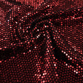 A swirled slink metallic spandex in the color black-red.