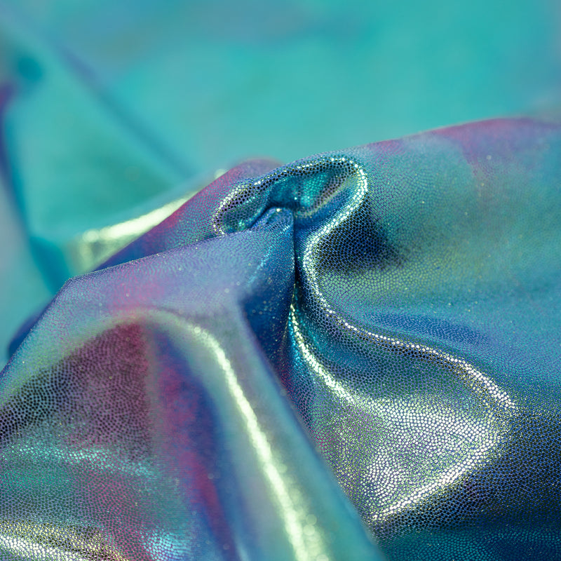 A swirled sample of snow cone foiled spandex in the color Cone-Blue-Pink
