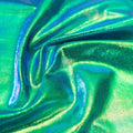 A swirled sample of snow cone foiled spandex in the color blue-green-rainbow.