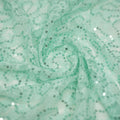A swirled sample of Sophia Stretch Lace Sequin in Mint.