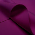 A curled piece of Spacer Scuba Knit in the color dark berry.