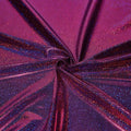 A folded sample of sparkles foiled spandex in the color black-fuchsia.