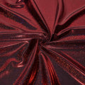A folded sample of sparkles foiled spandex in the color black-red.