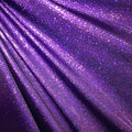 A folded sample of sparkles foiled spandex in the color eggplant purple.