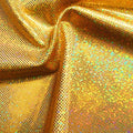 A folded sample of sparkles foiled spandex in the color gold-gold.