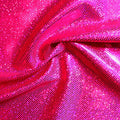 A folded sample of sparkles foiled spandex in the color rose-fuchsia.