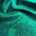 A folded sample of sparkles foiled spandex in the color teal-teal.