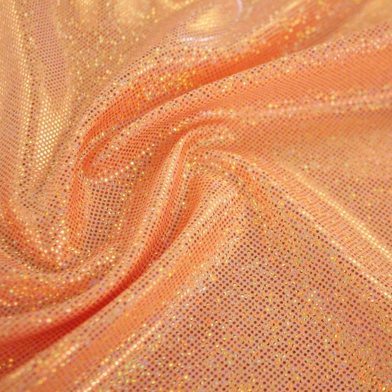 A swirled sample of sparkly foiled spandex in the color tangerine orange.