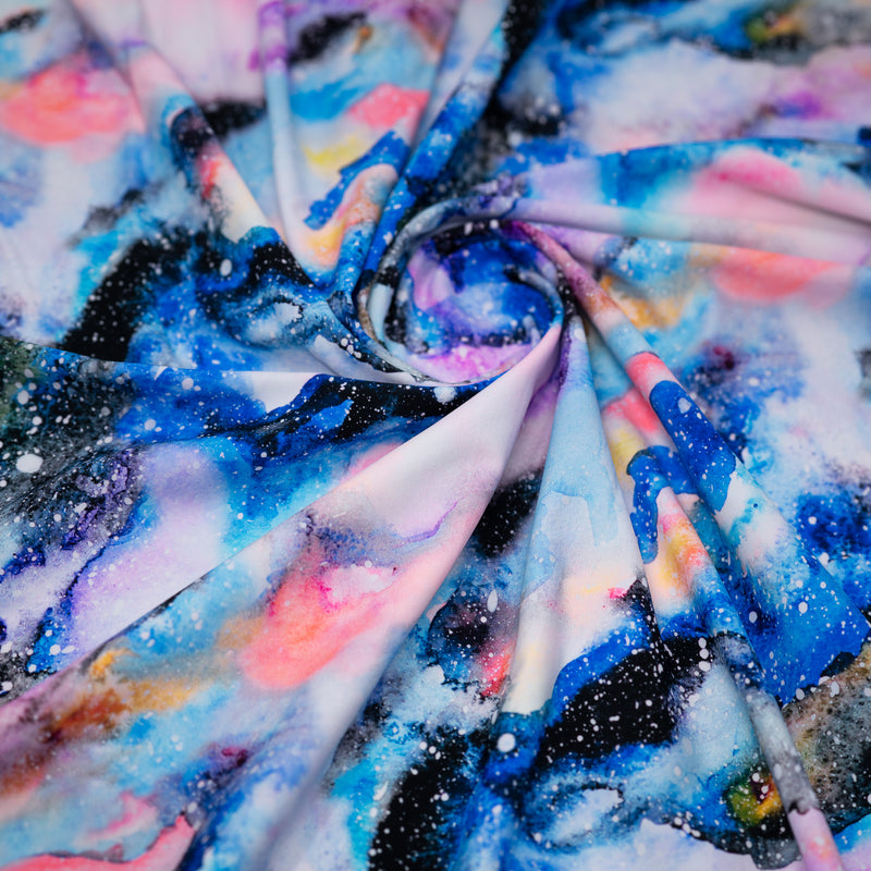 A swirled piece of Splatter Paint Galaxy Printed Spandex.