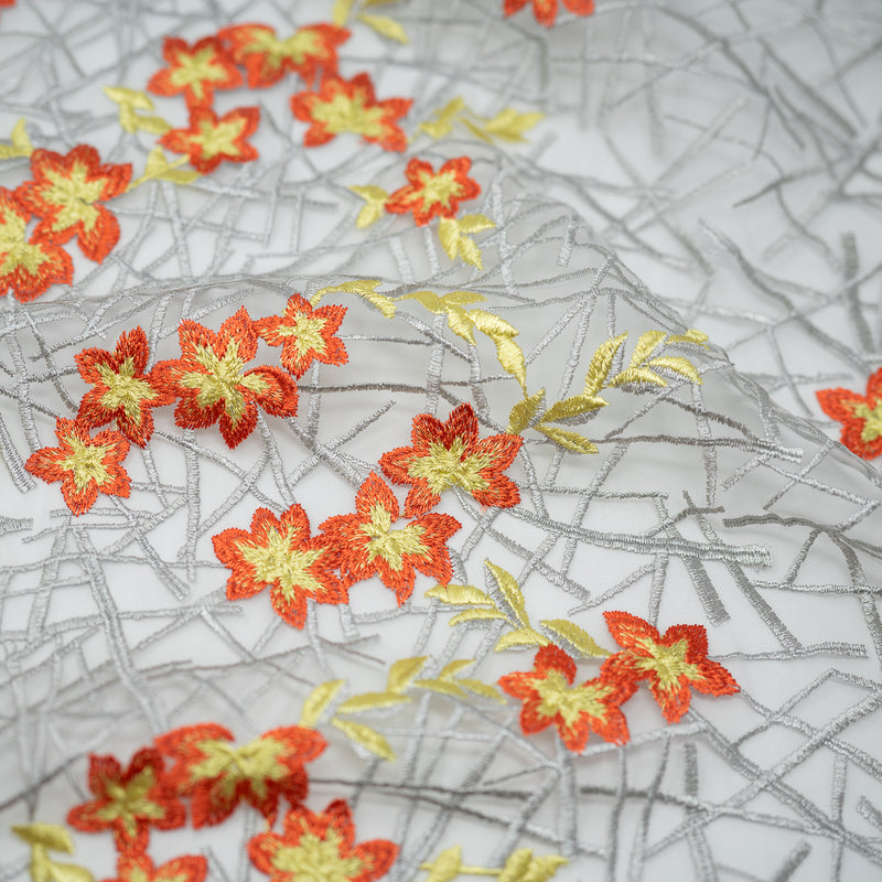 Detailed shot of Spring Has Sprung Embroidered Mesh Fabric in the color orange