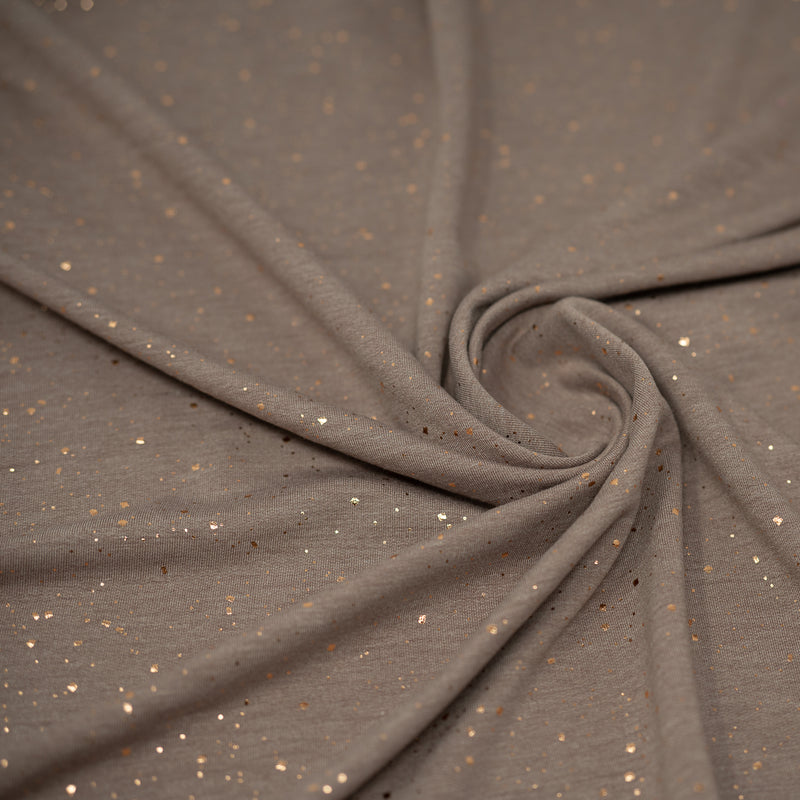 Detailed shot of Stardust Foil Printed Stretch French Terry in color Toasted Rose Gold.