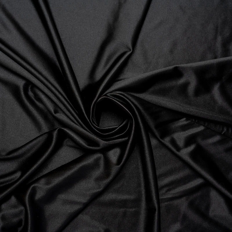 A swirled piece of stretch charmeuse satin in the color black.