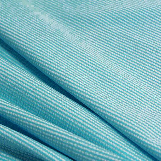 A rippled piece of stretch seersucker material in the color celeste blue.