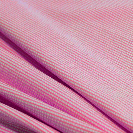 A rippled piece of stretch seersucker material in the color famous.