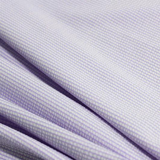 A rippled piece of stretch seersucker material in the color lilac.