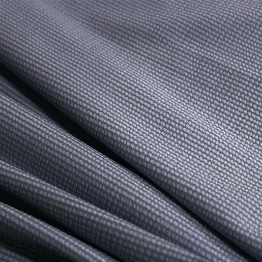 A rippled piece of stretch seersucker material in the color navy.