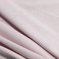 A rippled piece of Stretch Seersucker (1/8" Stripe) in the color Pink