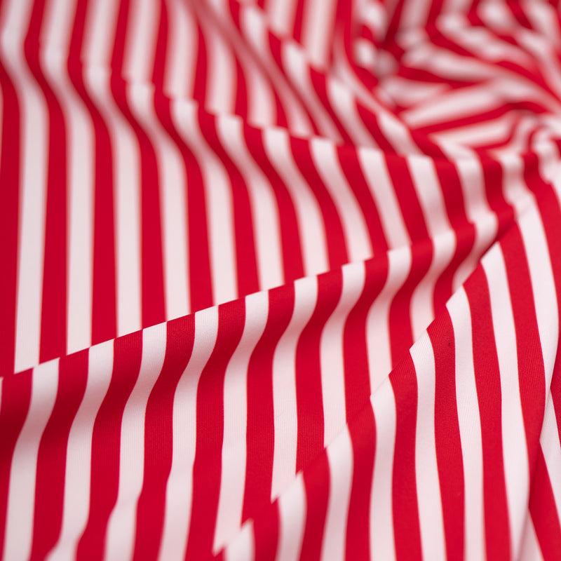 A crumpled piece of Striped 1/4" Printed Spandex in the color Red and White