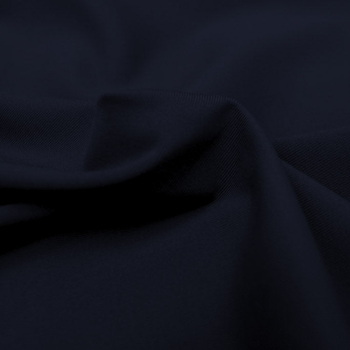 A swirled piece of Superflex Heavy Compression Spandex in the color midnight.