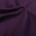 A swirled piece of Superflex Heavy Compression Spandex in the color plum.