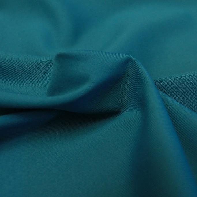 A swirled piece of Superflex Heavy Compression Spandex in the color teal.