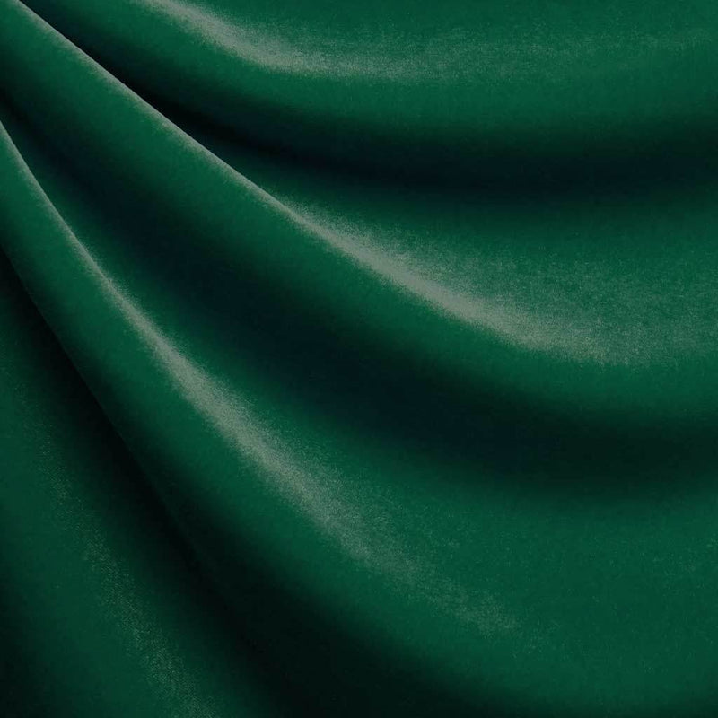 A drapped piece of Supreme Stretch Velvet in the color alpine green.