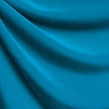 A drapped piece of Supreme Stretch Velvet in the color turquoise.