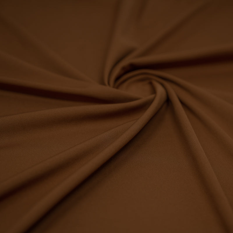 A swirled sample of TechFlex Micro Poly Spandex in color Chai.