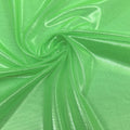 A swirled sample of ultrasheen foiled power mesh with a lime and lt. gold foil available at Blue Moon Fabrics.