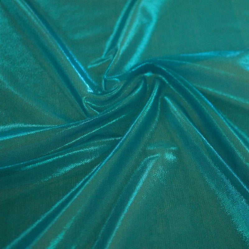 A swirled sample of ultrasheen foiled power mesh with a azul mesh and blue foil available at Blue Moon Fabrics.