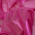 A swirled sample of ultrasheen foiled power mesh with a Berry mesh and Fuchsia foil available at Blue Moon Fabrics.