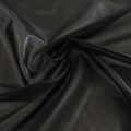 A swirled sample of ultrasheen foiled power mesh with black mesh and black foil available at Blue Moon Fabrics.