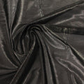A swirled sample of ultrasheen foiled power mesh in the color black gunmetal available at Blue Moon Fabrics.
