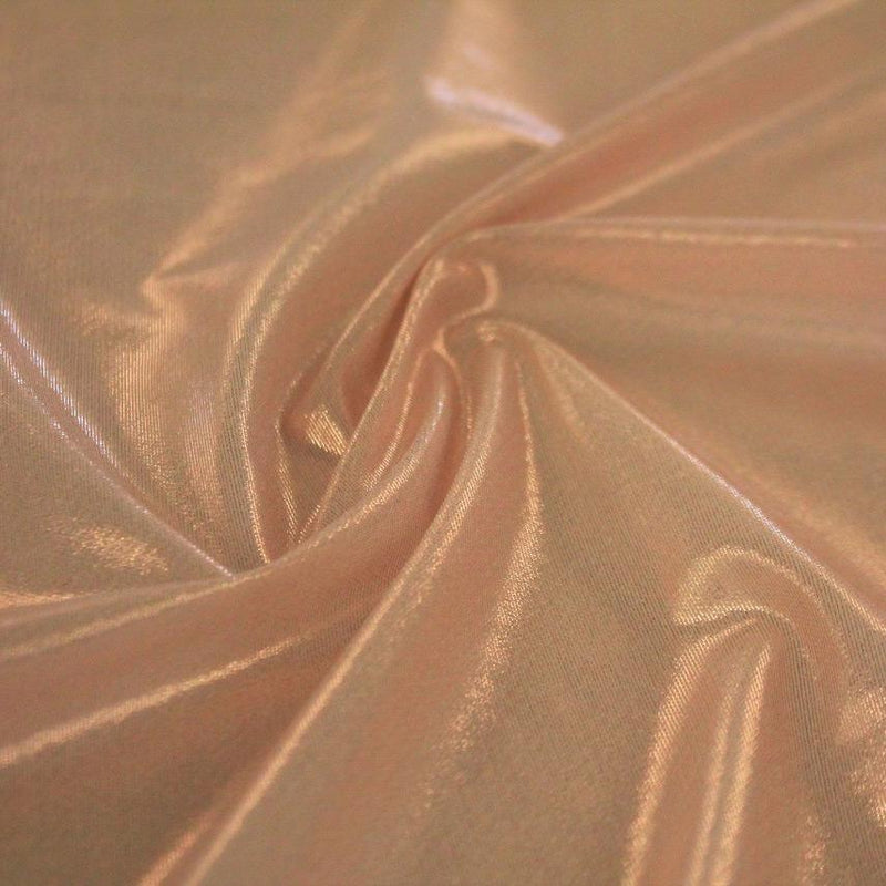 A swirled sample of ultrasheen foiled power mesh with a blush mesh and rose gold foil  available at Blue Moon Fabrics.