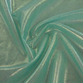 A swirled sample of ultrasheen foiled power mesh with a green mesh and mint foil available at Blue Moon Fabrics.