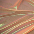 A swirled sample of ultrasheen foiled power mesh with a peach and oz foil available at Blue Moon Fabrics.