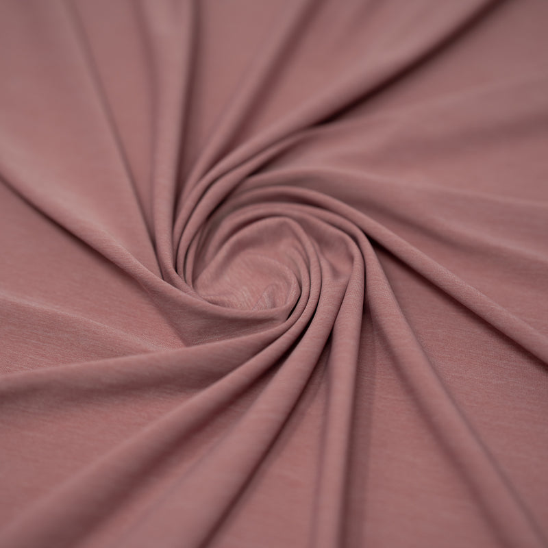 Shot of swirled UniFlex Nylon Polyester Spandex Reversible Knit Top Weight Fabric in color rose
