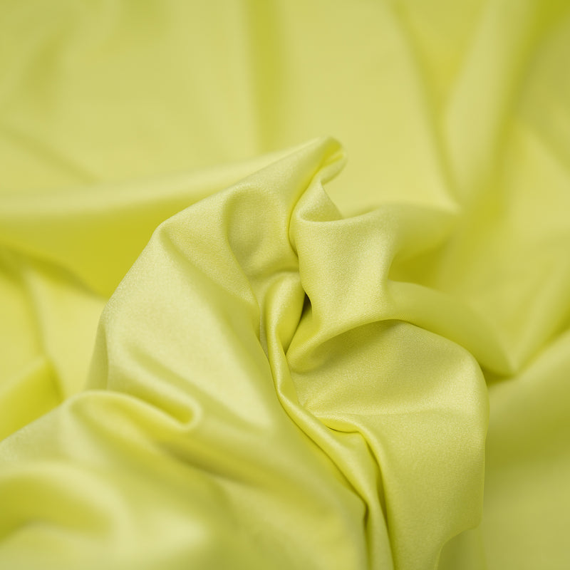 A swirled piece of nylon spandex fabric with an all over shiny look in the color Seagrass