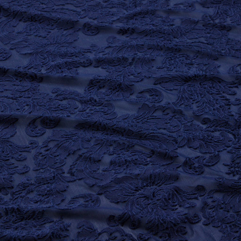 A flat sample of versailles burn out stretch velvet in the color navy.
