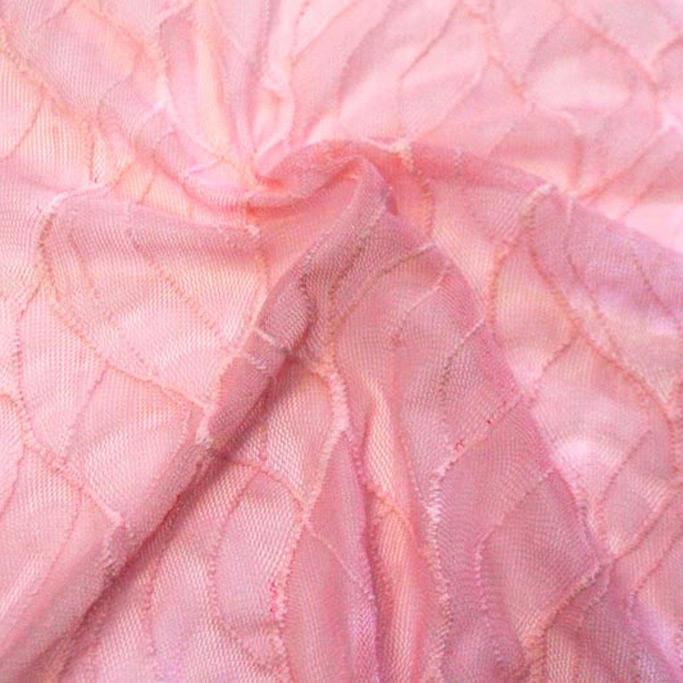 A swirled piece of wavy stretch mesh in the color baby pink.