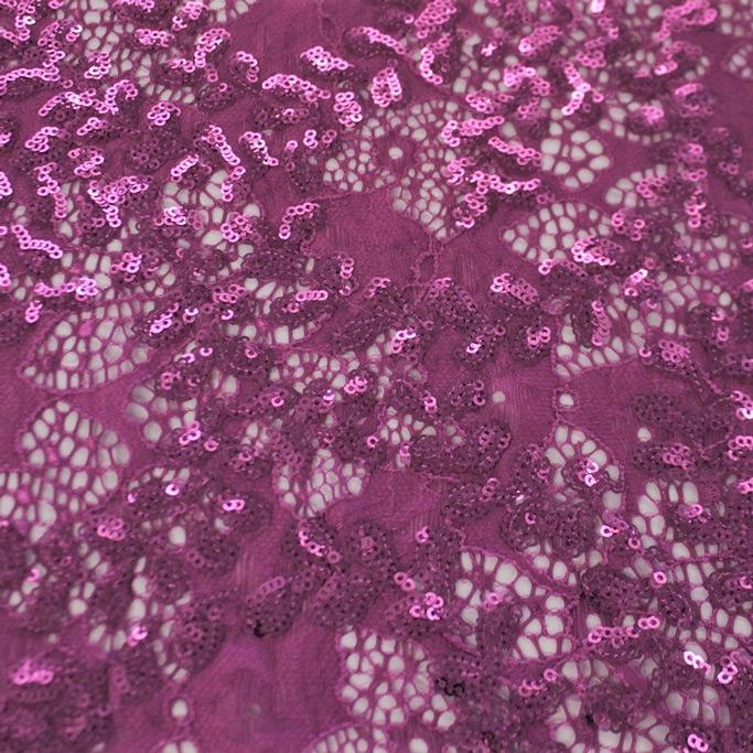 A flat sample of wisteria stretch lace sequin in the color magenta.