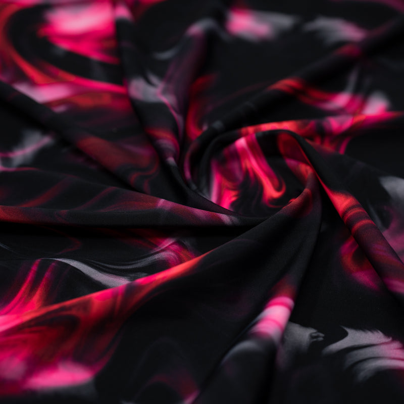 A swirled piece of Wormhole Wonderland Printed Spandex in black-red-pink